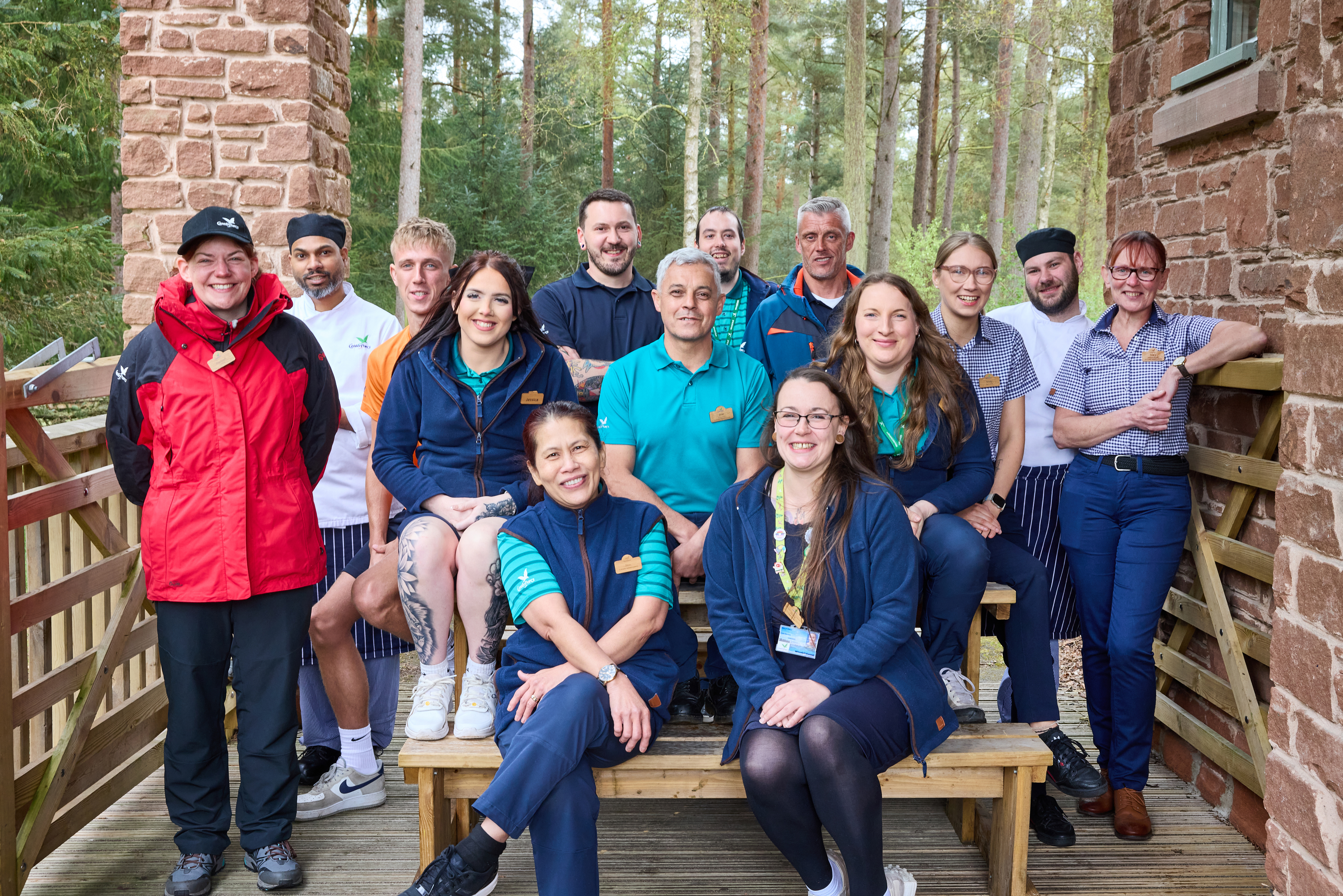 Group of people in uniforms posing outdoors.