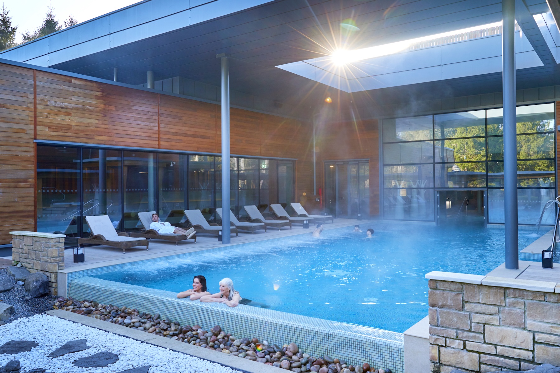 People enjoying a pool in a spa setting.