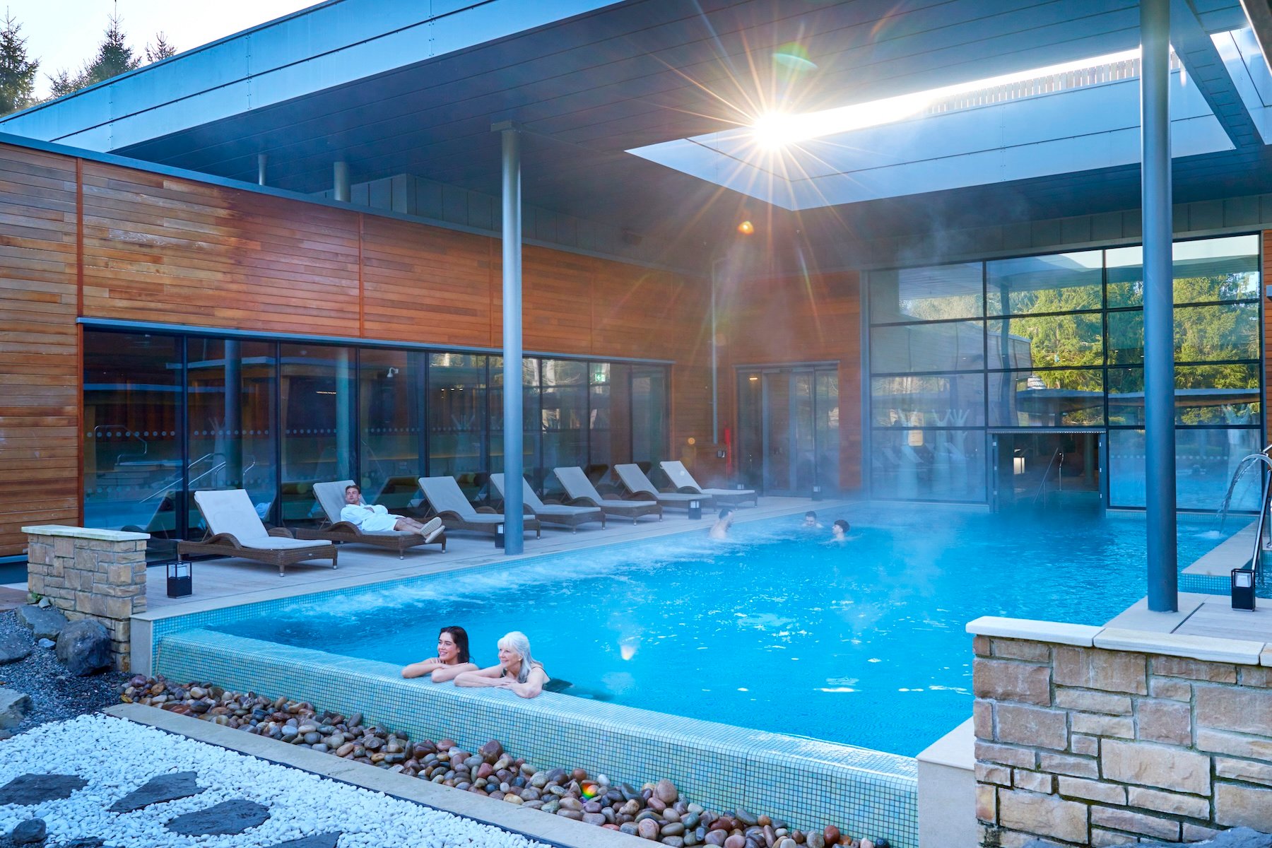 People enjoying a pool in a spa setting.